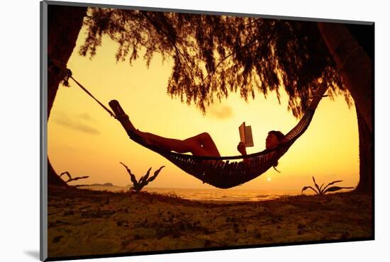 Young Lady Reading the Book in the Hammock on Tropical Beach at Sunset-Dudarev Mikhail-Mounted Photographic Print