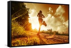 Young Lady Running on a Rural Road during Sunset-Dudarev Mikhail-Framed Stretched Canvas