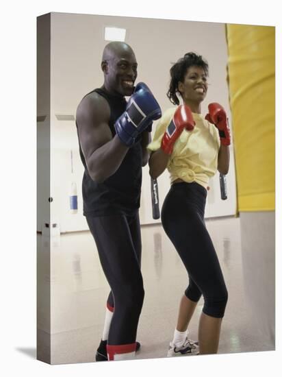Young Male Coach Coaching a Female Boxer-null-Stretched Canvas