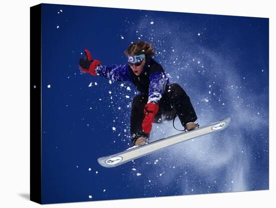 Young Male Snowboarder in Action-null-Stretched Canvas