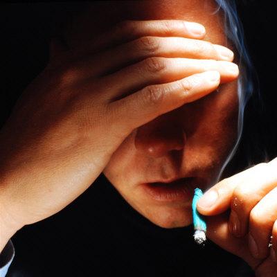'Young Man About to Take a Drag on a Marijuana Cigarette Wrapped in Blue Paper' Photographic