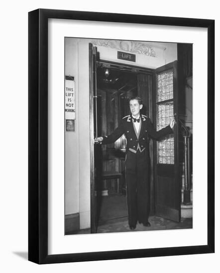 Young Man Blocking the Entrance to the "Lift", in America it Is Called an Elevator-null-Framed Photographic Print