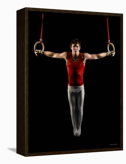 Young Man Exercising on Gymnastic Rings, Bainbridge Island, Washington State, USA-null-Framed Stretched Canvas