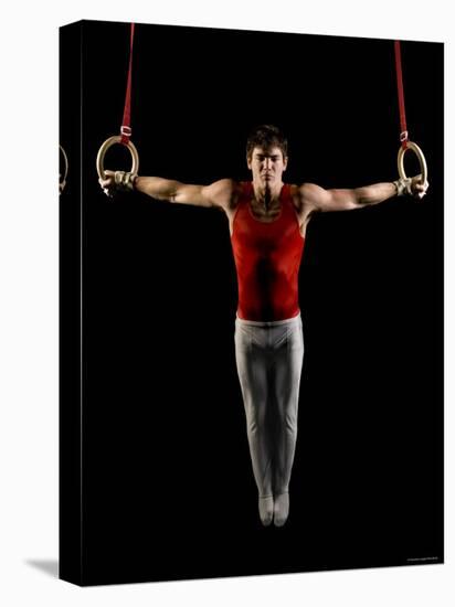 Young Man Exercising on Gymnastic Rings, Bainbridge Island, Washington State, USA-null-Stretched Canvas