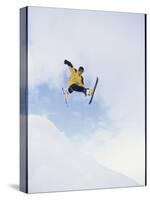 Young Man in Mid Air Wearing Skis-null-Stretched Canvas