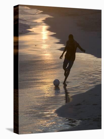 Young Man Playing Football at Sandbeach in Twilight, Santa Maria, Sal, Cape Verde, Africa-Michael Runkel-Stretched Canvas