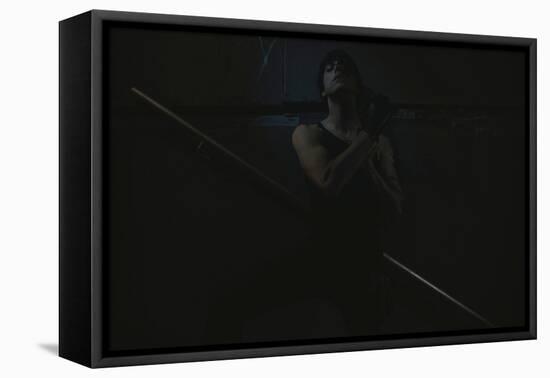 Young Man Posing in Dark Setting-Luis Beltran-Framed Stretched Canvas