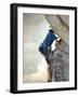 Young man rock climbing up a vertical cliff-null-Framed Photographic Print