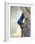 Young man rock climbing up a vertical cliff-null-Framed Photographic Print