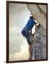 Young man rock climbing up a vertical cliff-null-Framed Photographic Print