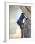 Young man rock climbing up a vertical cliff-null-Framed Photographic Print