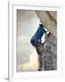 Young man rock climbing up a vertical cliff-null-Framed Photographic Print