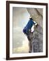 Young man rock climbing up a vertical cliff-null-Framed Photographic Print