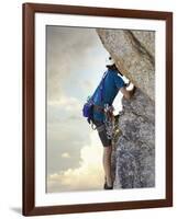 Young man rock climbing up a vertical cliff-null-Framed Photographic Print