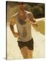 Young Man Running on the Beach-null-Stretched Canvas