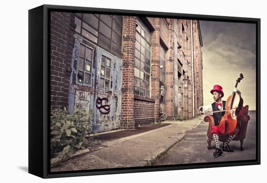 Young Man Sitting On An Armchair On A City Street And Playing The Cello-olly2-Framed Stretched Canvas