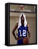 Young Man Standing Holding a Basketball with a Towel on His Head-null-Framed Stretched Canvas