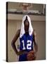 Young Man Standing Holding a Basketball with a Towel on His Head-null-Stretched Canvas