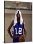 Young Man Standing Holding a Basketball with a Towel on His Head-null-Stretched Canvas