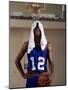 Young Man Standing Holding a Basketball with a Towel on His Head-null-Mounted Photographic Print