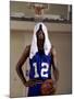 Young Man Standing Holding a Basketball with a Towel on His Head-null-Mounted Photographic Print