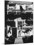 Young Man Standing in Front of a Herbs and Fish Market Displaying Racks of Fish-Howard Sochurek-Mounted Photographic Print