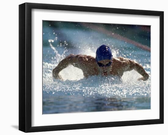 Young Man Swimming the Butterfly Stroke-null-Framed Premium Photographic Print