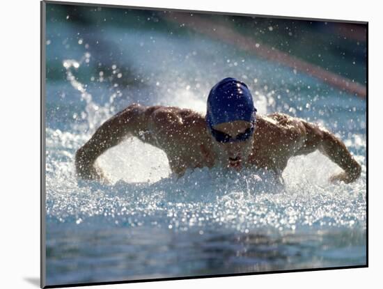 Young Man Swimming the Butterfly Stroke-null-Mounted Premium Photographic Print