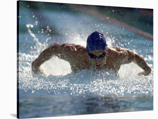 Young Man Swimming the Butterfly Stroke-null-Stretched Canvas