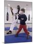 Young Man Teaching a Boy Martial Arts-null-Mounted Photographic Print