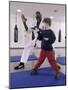 Young Man Teaching a Boy Martial Arts-null-Mounted Photographic Print