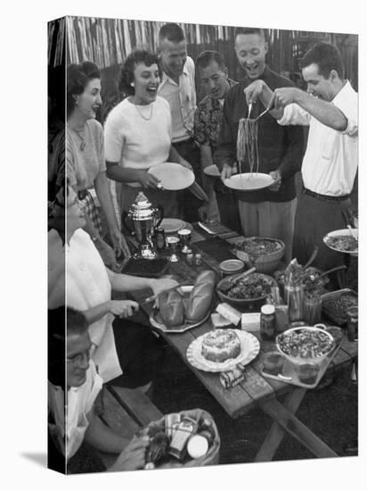 Young Married Couples Enjoying a Backyard Buffet Feast , Featuring Spaghetti-Nina Leen-Stretched Canvas