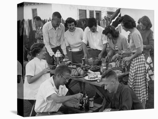 Young Married Couples Enjoying a Backyard Buffet Feast on Picnic Table-null-Stretched Canvas