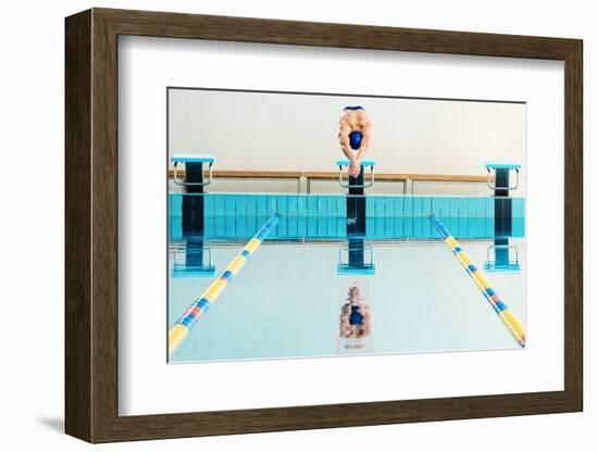 Young Muscular Swimmer Jumping from Starting Block in a Swimming Pool-NejroN Photo-Framed Photographic Print