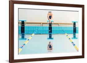 Young Muscular Swimmer Jumping from Starting Block in a Swimming Pool-NejroN Photo-Framed Photographic Print