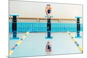 Young Muscular Swimmer Jumping from Starting Block in a Swimming Pool-NejroN Photo-Mounted Photographic Print