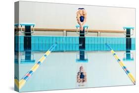 Young Muscular Swimmer Jumping from Starting Block in a Swimming Pool-NejroN Photo-Stretched Canvas