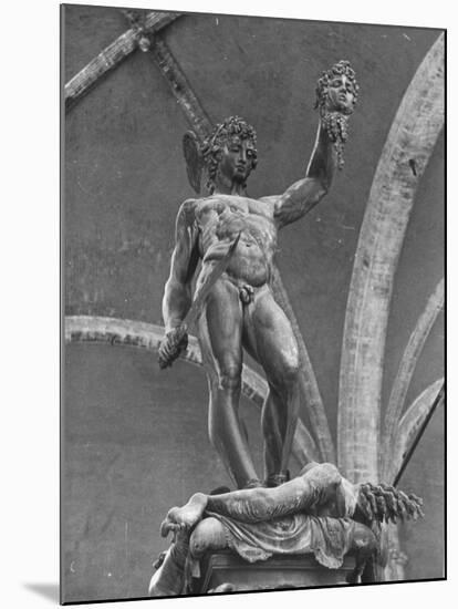 Young Perseus Holding the Decapitated Gorgon Head of Medusa, Standing over Her Body-Carl Mydans-Mounted Photographic Print