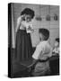 Young School Teacher Explaining to a Little Chinese Boy the Writings on Card That She Is Holding-null-Stretched Canvas
