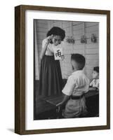 Young School Teacher Explaining to a Little Chinese Boy the Writings on Card That She Is Holding-null-Framed Photographic Print