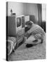 Young Woman Attending to Her Housework by Dusting Off Her Television Set-Nina Leen-Stretched Canvas