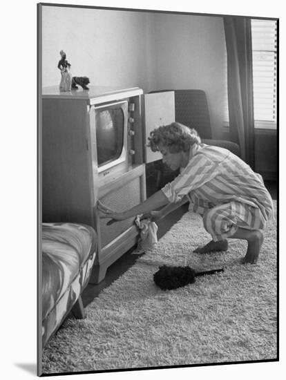 Young Woman Attending to Her Housework by Dusting Off Her Television Set-Nina Leen-Mounted Photographic Print