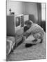 Young Woman Attending to Her Housework by Dusting Off Her Television Set-Nina Leen-Mounted Photographic Print