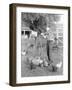 Young Woman Dressed as a Farmer Bringing Food to the Chicken-null-Framed Photo