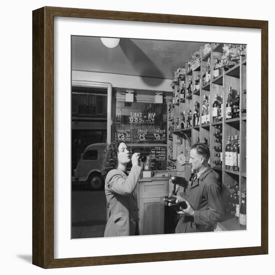 Young Woman Drinking a Bottle of Coca Cola in a Shop, Paris, France, 1950-Mark Kauffman-Framed Photographic Print