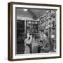 Young Woman Drinking a Bottle of Coca Cola in a Shop, Paris, France, 1950-Mark Kauffman-Framed Photographic Print