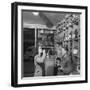 Young Woman Drinking a Bottle of Coca Cola in a Shop, Paris, France, 1950-Mark Kauffman-Framed Photographic Print