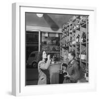 Young Woman Drinking a Bottle of Coca Cola in a Shop, Paris, France, 1950-Mark Kauffman-Framed Photographic Print