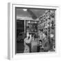 Young Woman Drinking a Bottle of Coca Cola in a Shop, Paris, France, 1950-Mark Kauffman-Framed Photographic Print