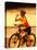 Young Woman Drinking Water Sitting on a Bicycle-null-Stretched Canvas